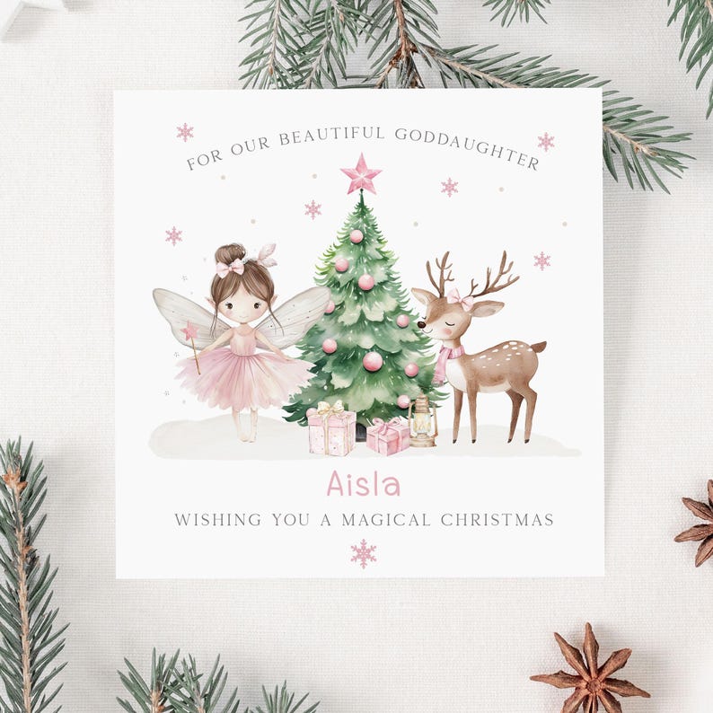 May include: A Christmas card with a fairy, deer, and Christmas tree illustration. The fairy wears a pink tutu and has wings. The deer has a pink scarf. The card reads "For our beautiful goddaughter" and "Wishing you a magical Christmas."