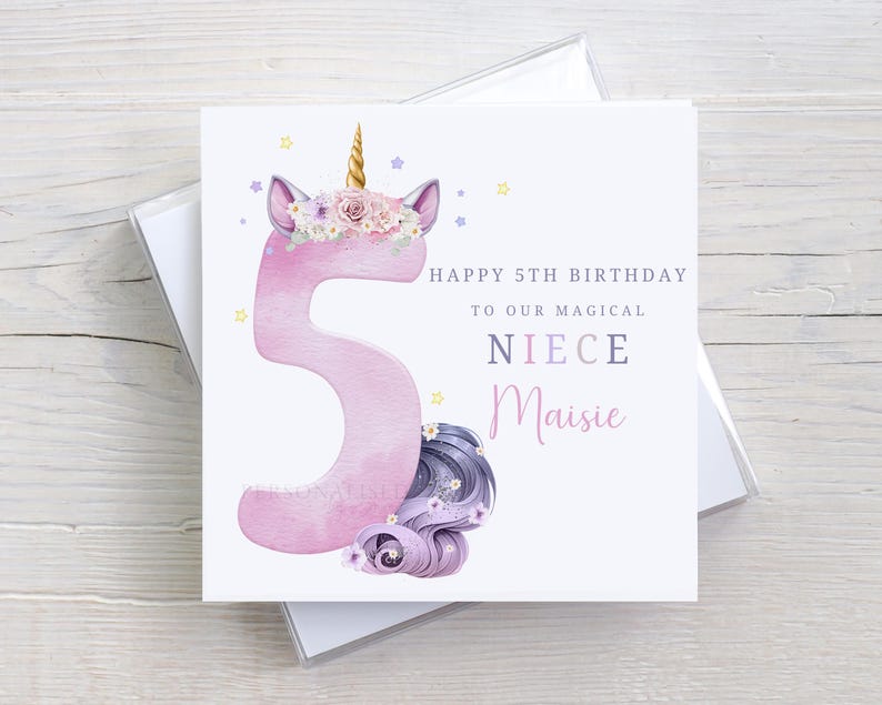 May include: A pink unicorn with a gold horn and purple flowers on its head. The unicorn is holding a pink number 5. The card says "Happy 5th Birthday to our magical niece Maisie".