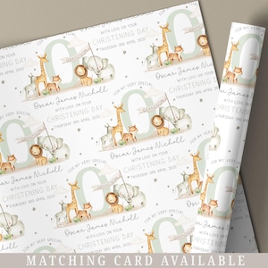 May include: Wrapping paper featuring a repeating pattern of safari animals such as giraffes, lions, and elephants. The design includes the text "Oscar James Nicholl, Christening Day, Thursday 3rd April 2025" and "Grandson". The words "Matching Card Available" are at the bottom.