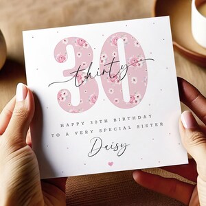 May include: A pink floral birthday card with the number 30 in a floral pattern. The card says "Happy 30th Birthday to a very special sister Daisy".