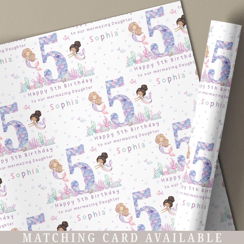 May include: White wrapping paper with a repeating pattern of purple and pink mermaids, seashells, and the number 5. The text "Happy 5th Birthday to our mermazing Daughter Sophia" is repeated throughout the pattern.