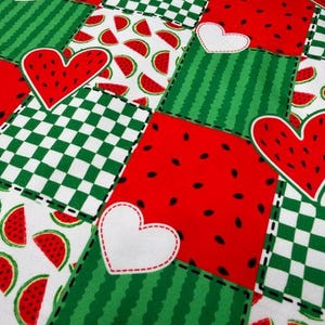 May include: A patchwork fabric design featuring red, green, and white squares. The squares display watermelon slices, hearts, and striped and checkered patterns. The fabric is stitched together with black thread, creating a vibrant and playful summer theme.