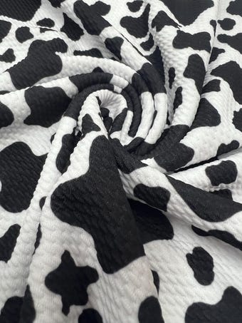 Black and White Cow Bullet Fabric on bullet liverpool knit fabric