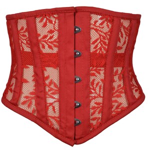 May include: A red corset with a lace overlay and a busk closure. The corset has a pointed bottom and is made of a soft, stretchy fabric.
