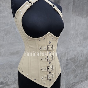 May include: A beige corset with a halter neck and multiple buckles. The corset is displayed on a black mannequin. The text "FanicaFashoin" is printed on the corset.