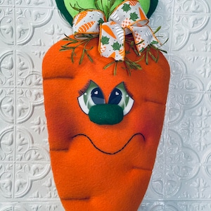 Carrot Wreath Attachment or Door Decor. This silly guy has bright green eyes and a big smile to greet you.Approximately 18” long and 9”wide