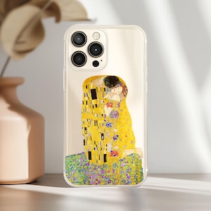 May include: Transparent phone case displaying Gustav Klimt's "The Kiss" artwork. The design features a couple embracing, in gold, yellow, and black tones, set against a floral backdrop. The case is designed for a smartphone.
