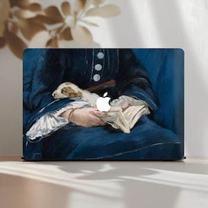 May include: Laptop skin featuring a detail from a classic painting. The artwork depicts a person in a dark blue dress holding a small dog and a book. The Apple logo is visible on the laptop.