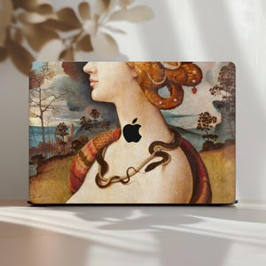 MacBook case with vintage portrait painting detail, featuring a woman with braided hair, a snake necklace, and a dreamy landscape background in romantic renaissance style