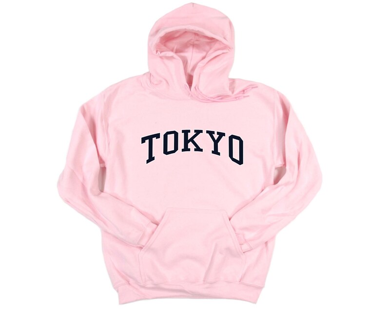 May include: A pink hooded sweatshirt with the word "TOKYO" printed in black on the front.