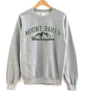 May include: Grey sweatshirt with a green graphic print of mountains and the text "MOUNT BAKER Washington".