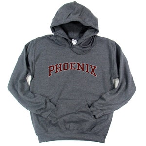 May include: A dark gray hooded sweatshirt with the word "PHOENIX" in maroon lettering across the front.