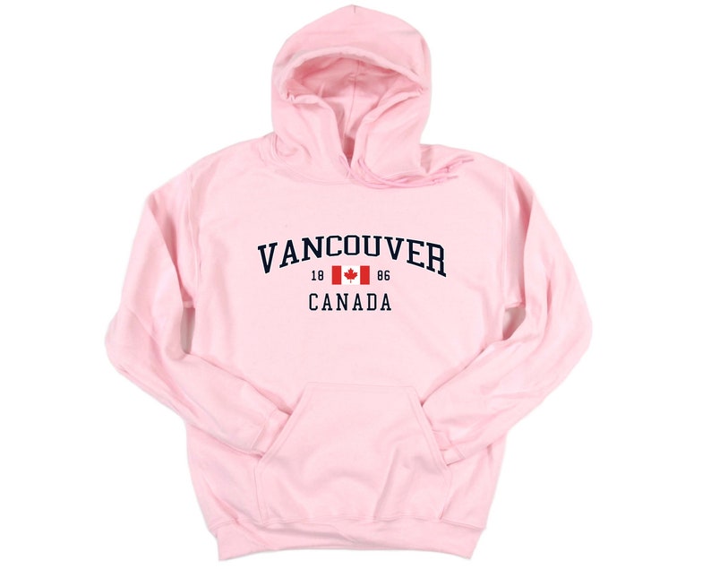 May include: Pink hooded sweatshirt with the text "VANCOUVER 18 86 CANADA" and a Canadian flag graphic.
