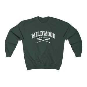May include: A dark green sweatshirt with the text "WILDWOOD NEW JERSEY" in white with a pair of crossed oars underneath.