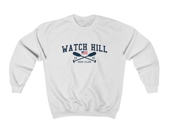 May include: White sweatshirt with a navy blue graphic of the text "WATCH HILL" with a small American flag and crossed oars. The text "18" and "45" are on either side of the flag and the text "RHODE ISLAND" is below the oars.