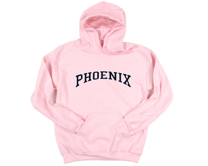May include: A pink hooded sweatshirt with the word "PHOENIX" printed in a navy blue arched font.