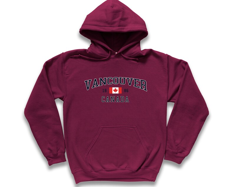 May include: A maroon hooded sweatshirt with a navy blue graphic that says "Vancouver" with the Canadian flag and "1866 Canada" underneath.