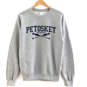 May include: Gray sweatshirt with a navy blue print that says "Petoskey Michigan" with two crossed oars.