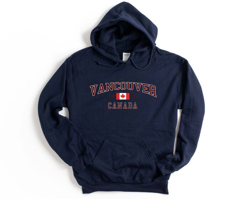 May include: Navy blue hooded sweatshirt with the text "Vancouver, Canada" and a Canadian flag graphic.