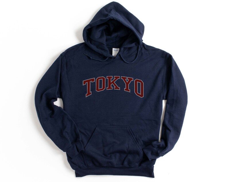 May include: Navy blue hooded sweatshirt with the word "TOKYO" in maroon letters.