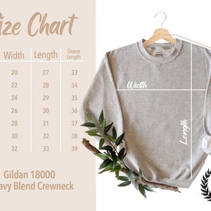 May include: A light gray Gildan 18000 Heavy Blend Crewneck sweatshirt hangs on a wooden hanger. A size chart shows measurements in inches for width, length, and sleeve length. The City & State logo is in the lower right corner.