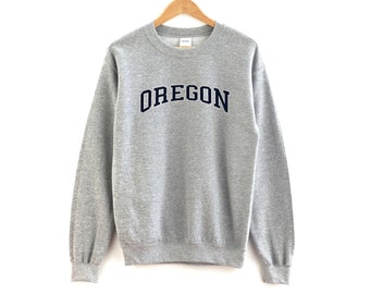 May include: A gray sweatshirt with the word "OREGON" printed in navy blue on the front.