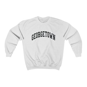May include: White sweatshirt with black text that reads "GEORGETOWN" in an arched font.