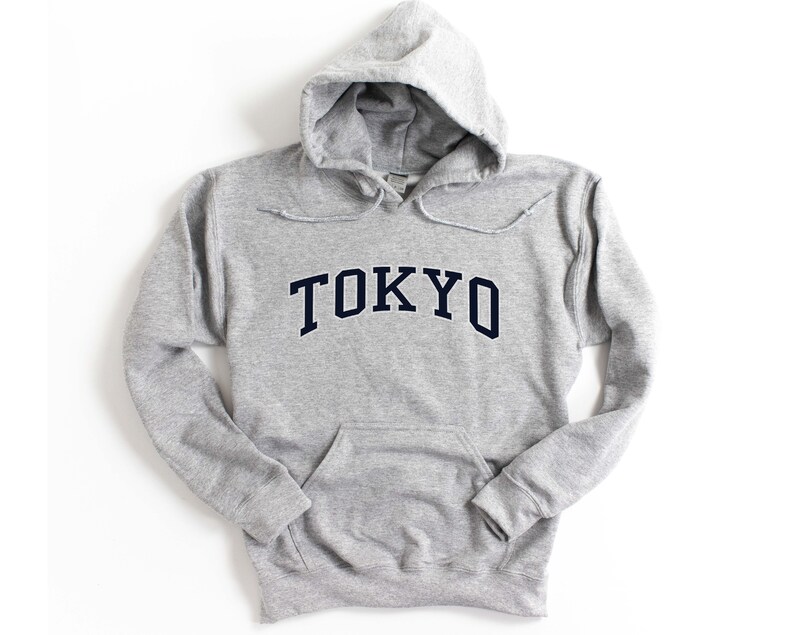 May include: A gray hooded sweatshirt with the word "TOKYO" printed in navy blue on the front.