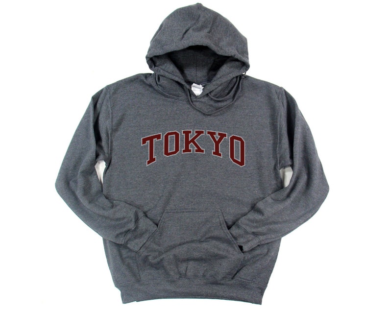 May include: A dark gray hooded sweatshirt with the word "TOKYO" printed in maroon on the front.