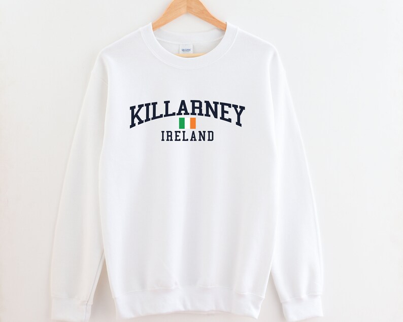 May include: White sweatshirt with a navy blue print that says "KILLARNEY IRELAND" with an Irish flag graphic.