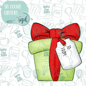 May include: A digital graphic of a light green gift box wrapped with a bright red ribbon and bow. A white gift tag is attached to the ribbon with the text TO: and FROM: printed in black. The background features a repeating pattern of baking tools.