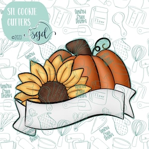 May include: A cookie cutter set featuring a pumpkin and sunflower design. The pumpkin is orange and the sunflower is yellow with brown center. The cutters are on a white background with a banner that says "Flour".