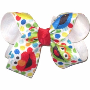 Medium Elmo, Big Bird, Oscar, Cookie Monster Hair Bow. Over White with Yellow and Blue. Ages 5 to 7.