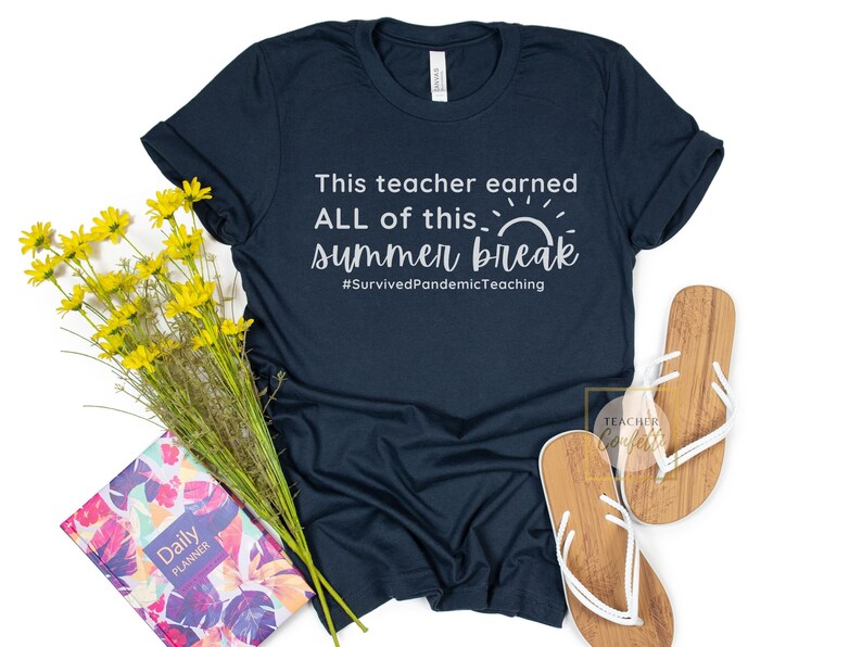 May include: A dark blue t-shirt with the text "This teacher earned ALL of this summer break #SurvivedPandemicTeaching" in white. The shirt features a white sun graphic.
