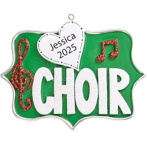 May include: Green Christmas ornament with a white heart that says "Jessica 2025" and the word "CHOIR" in white letters. There is a red treble clef and a red musical note on the ornament.