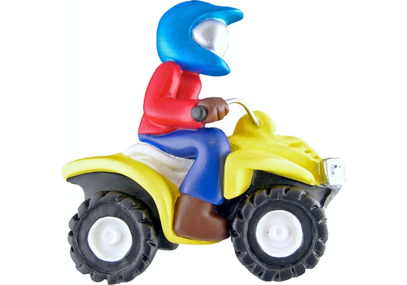 May include: A yellow toy ATV with a blue helmet-wearing figure driving it. The figure is wearing a red shirt and blue pants.