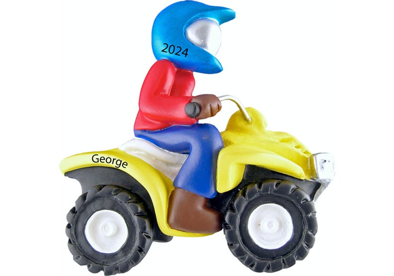 May include: A yellow ATV with a blue helmet and red shirt. The ATV has the name "George" on the side and the number "2024" on the helmet.