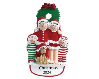 May include: A Christmas ornament featuring a family of four in red and white pajamas with a dog. The ornament is decorated with a green wreath and the text "Christmas 2024".