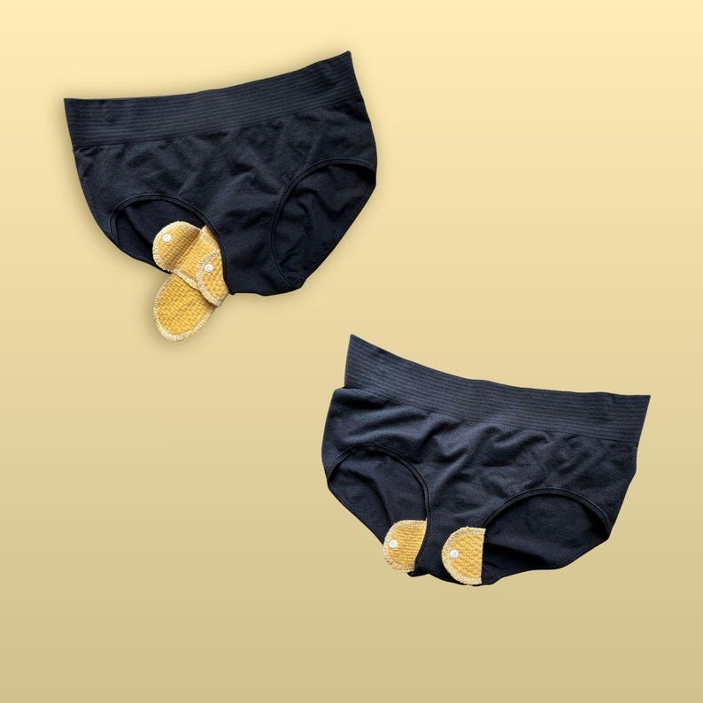 Two views of a Golden Sand reusable cloth pad secured around black underwear, showing the closed snap wings underneath and the pad positioned through the gusset.