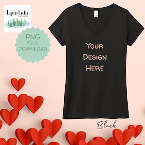 May include: Black V-neck t-shirt with the text "YOUR DESIGN HERE" in pink. The shirt is surrounded by red paper hearts.