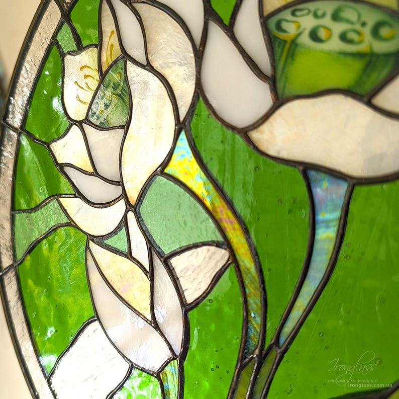 Tilted ultra close-up of the upper section of the stained glass panel with White lilies, showing the intricate hand-painted seed pod and the soldered chain detail for the windows hangings display.