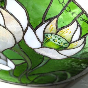 Extreme close-up, angled view of the stained glass panel, focusing on the central White Lilies bloom and the hand-painted details on the stamens, emphasizing the high-quality tiffany glass art technique.