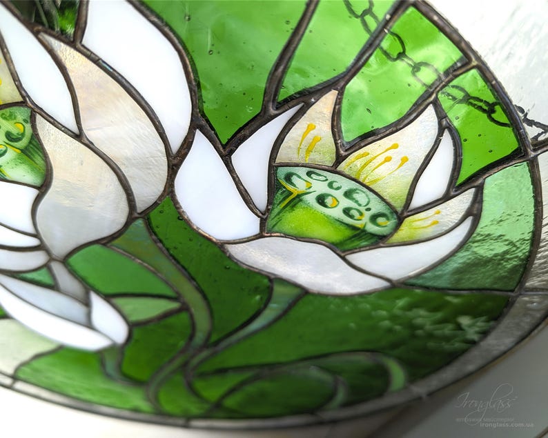 Extreme close-up, angled view of the stained glass panel, focusing on the central White Lilies bloom and the hand-painted details on the stamens, emphasizing the high-quality tiffany glass art technique.