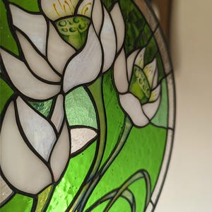 Extreme close-up, angled shot of the White Lilies stained glass panel, showing the mother-of-pearl shimmer on the petals and the intricate details of the flower stamens; a unique piece of pastel wall art and perfect mothers gift.