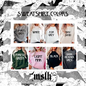 May include: A chart showing different sweatshirt colors available for purchase. The colors include: Sports Grey, White, Ash Grey, Tan/Sand, Forest Green, Light Pink, Black, and Dark Heather Grey.