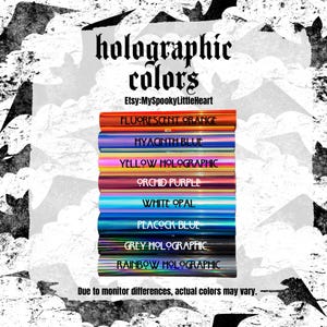 May include: A stack of eight rectangular holographic color samples labeled Fluorescent Orange, Hyacinth Blue, Yellow Holographic, Orchid Purple, White Opal, Peacock Blue, Grey Holographic, and Rainbow Holographic, with text reading holographic colors and Etsy:MySpookyLittleHeart.