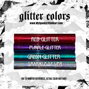 May include: Four rolls of glitter adhesive vinyl in red, purple, green, and silver. The text "glitter colors" and "www.MySpookyLittleHeart.com" is printed above the rolls. The text "DUE TO MONITOR DIFFERENCES, ACTUAL COLOR MAY VARY." is printed below the rolls.