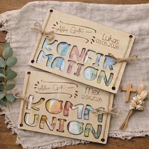 May include: Two wooden gift card holders with cut-out letters spelling "KONFIRMATION" and "KOMMUNION", filled with colorful currency. The top holder has the text "Alles Gute zur Lukas 03.05.2026". The bottom holder has the text "Alles Gute zur Mex 12.04.2026".
