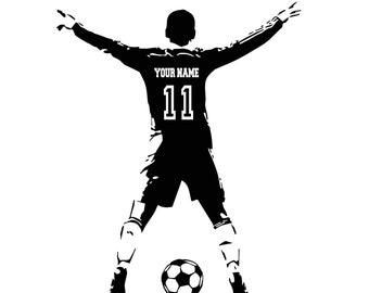 May include: Black and white silhouette of a soccer player with arms raised in celebration. The player is wearing a jersey with the number 11 and the text "YOUR NAME". A soccer ball is in front of the player.
