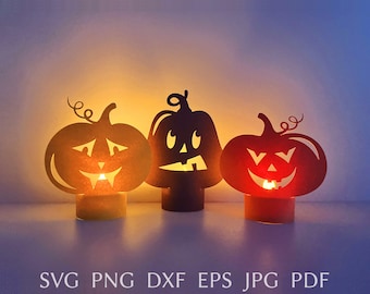 May include: Three orange paper jack-o'-lantern candle holders with black cut-out faces. The candle holders are lit and glowing.